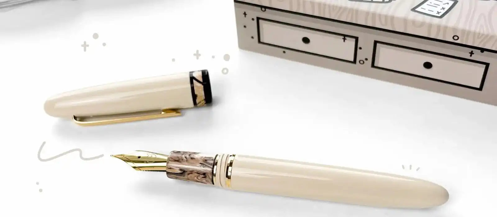 Ivory-colored fountain pen with gold nib and marbled grip.
